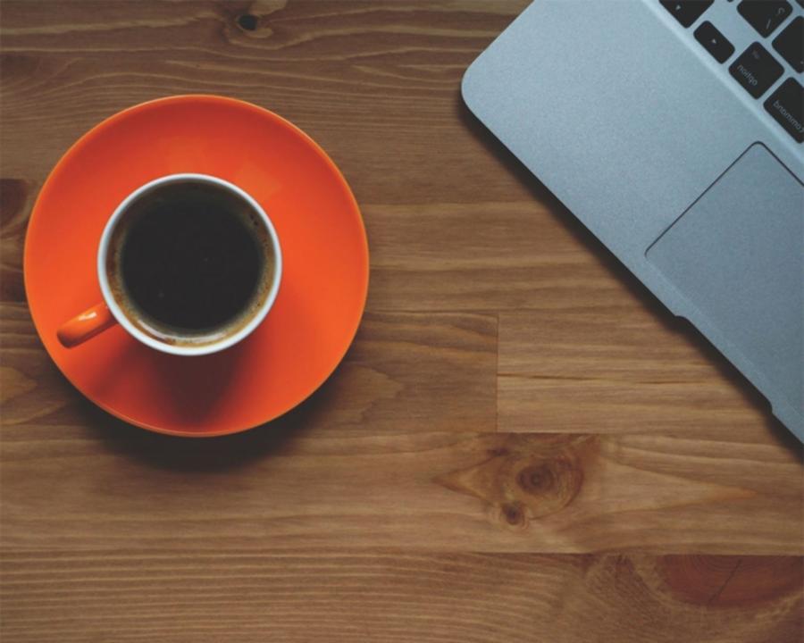 Empty theatre stage with single spotlight and scattered props